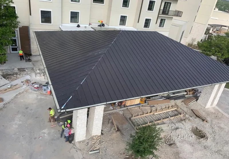 Metal roofing installation team working on a commercial building in Lloyd